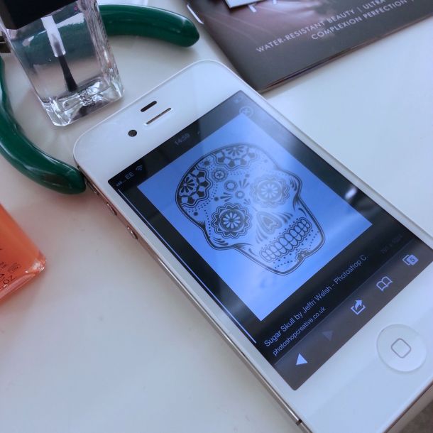 Picture of a sugar skull on an iPhone.