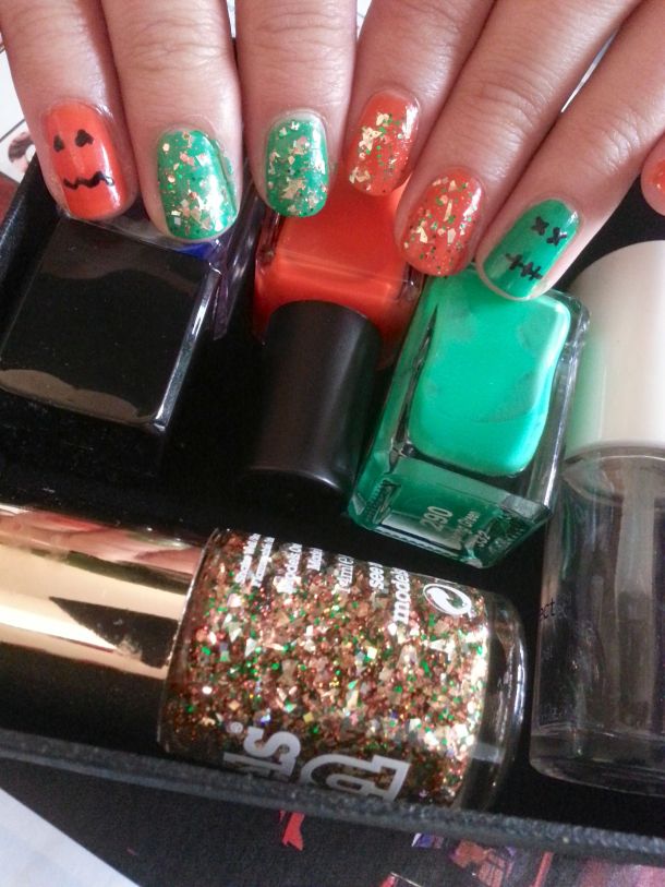 spooky halloween-themed nails with jack-o-lantern and frankenstein detailing